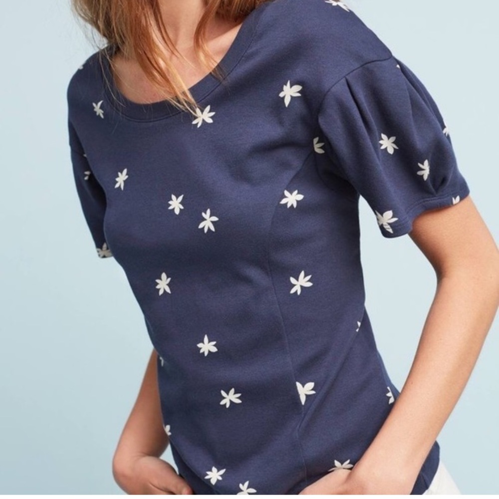 Anthropologie navy blue top with white floral Jasmine print. Puff short sleeves.